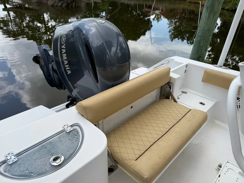 Slide: The Image of The image shows the stern of a Sportsman Heritage 211 Center Console boat with a Yamaha outboard motor. - 30