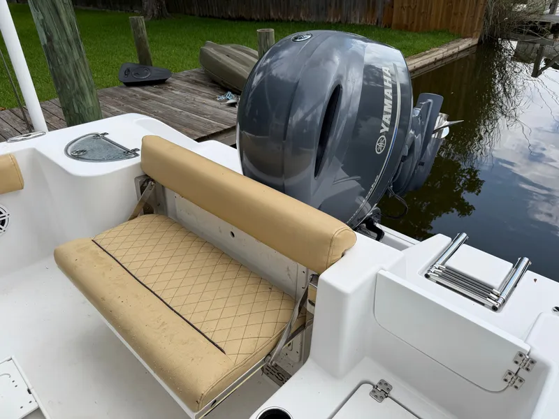 Slide: The Image of The image shows the stern of a 2021 Sportsman Heritage 211 Center Console boat with a Yamaha outboard motor. - 31
