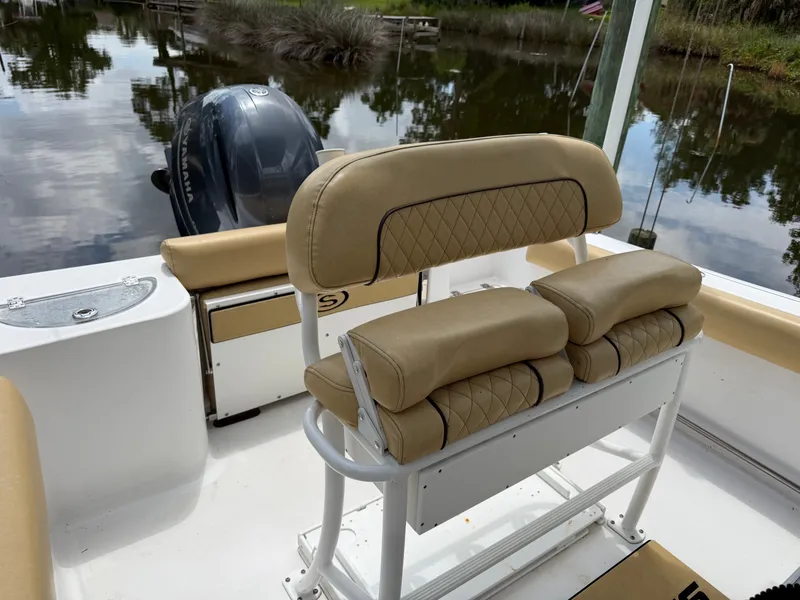 Slide: The Image of Sportsman Heritage 211 Center Console 2021 with beige upholstery and outboard motor. - 37