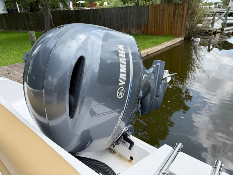 Slide: The Image of A Yamaha outboard motor on a Sportsman Heritage 211 Center Console boat docked in a calm area. - 39