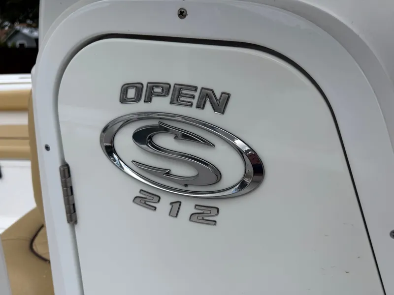Slide: The Image of Close-up of a boat door with "OPEN 212" and an oval logo. - 49