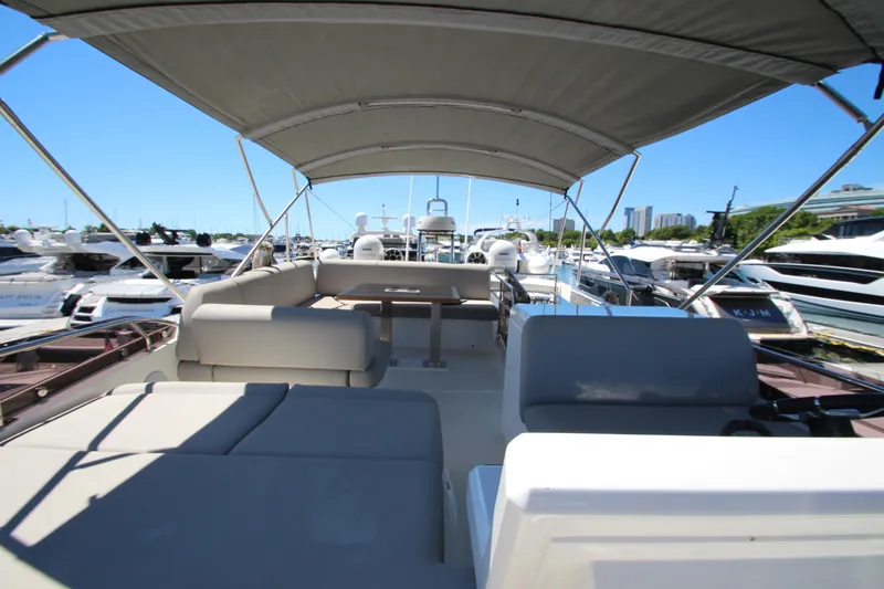 Slide: The Image of Luxurious 2022 Prestige 520 yacht interior with canopy, docked at marina. - 104