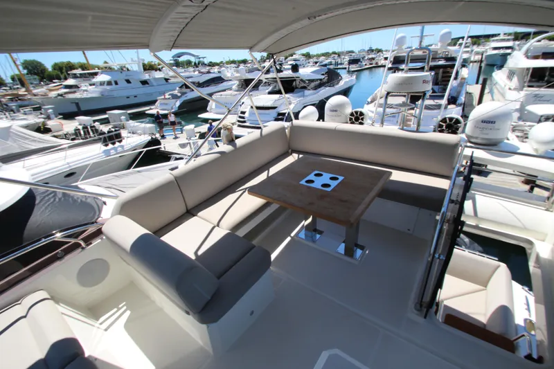 Slide: The Image of Luxurious 2022 Prestige 520 yacht with spacious seating and elegant design at a marina. - 109