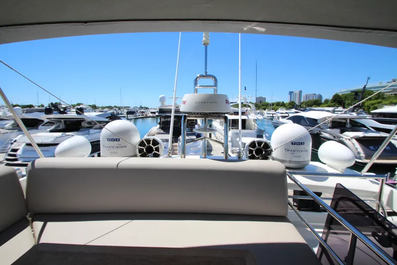 Slide: The Image of Prestige 520 yacht, 2022 model, docked in a marina with clear blue skies. - 111