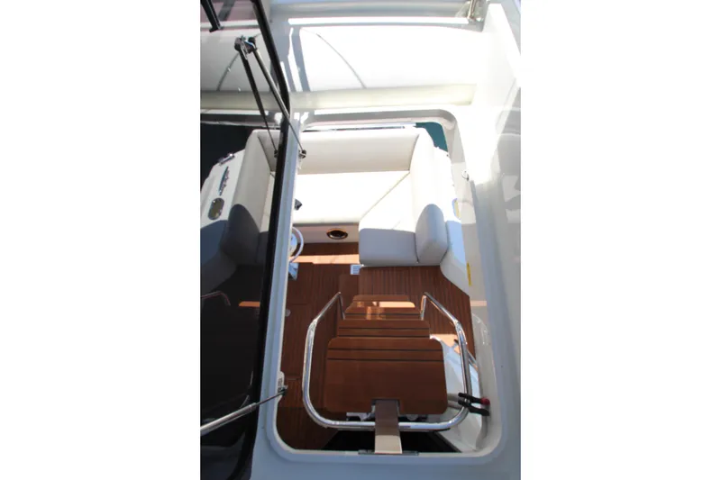Slide: The Image of Interior view of 2022 Prestige 520 yacht, featuring wooden steps and white seating. - 113