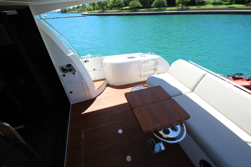 Slide: The Image of Luxurious 2022 Prestige 520 yacht deck with seating, overlooking serene blue waters. - 114