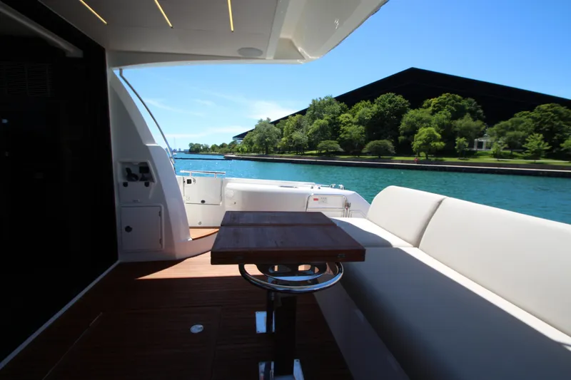 Slide: The Image of Luxury yacht Prestige 520, 2022 model, with elegant deck and scenic waterfront view. - 118