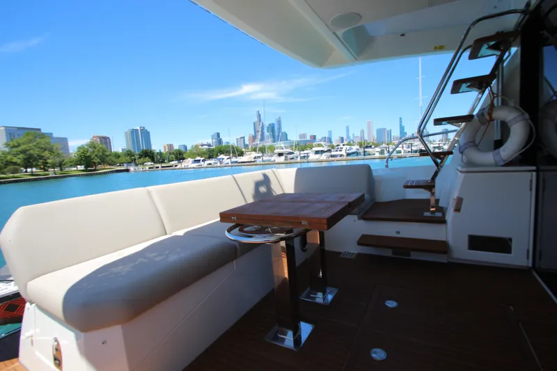 Slide: The Image of Luxurious 2022 Prestige 520 yacht with city skyline and marina view. - 128