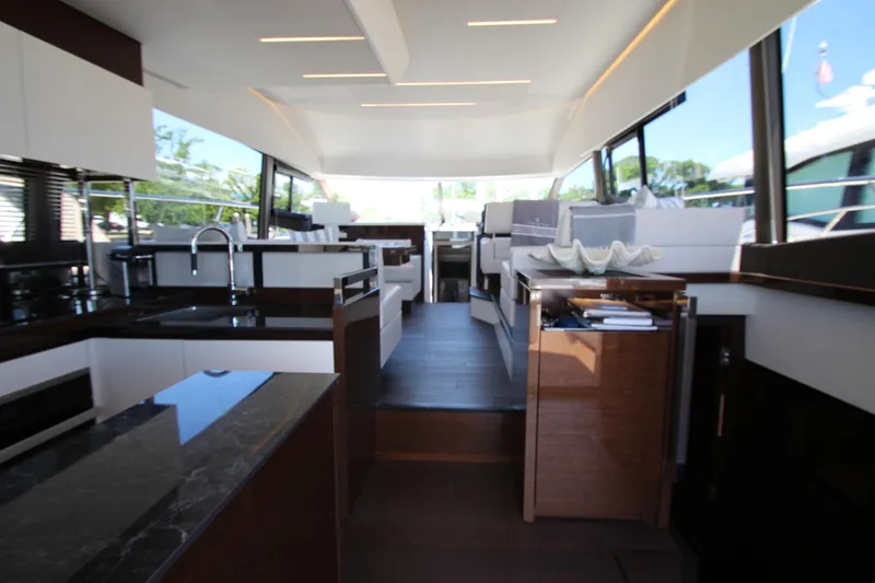 Slide: The Image of Luxurious interior of 2022 Prestige 520 yacht with modern kitchen and seating area. - 14
