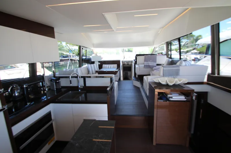 Slide: The Image of Luxurious interior of 2022 Prestige 520 yacht with modern kitchen and seating area. - 15