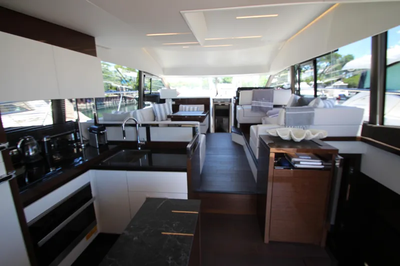 Slide: The Image of Luxurious interior of 2022 Prestige 520 yacht featuring modern kitchen and elegant seating area. - 16