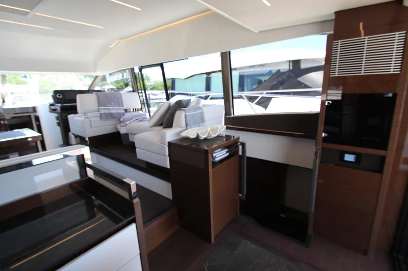 Slide: The Image of Luxurious interior of a 2022 Prestige 520 yacht with modern furnishings and large windows. - 18