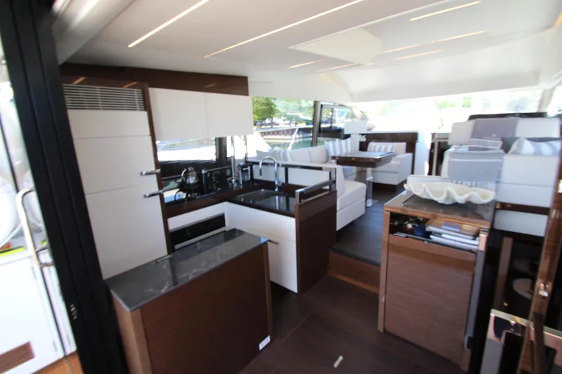 Slide: The Image of Luxurious interior of 2022 Prestige 520 yacht featuring modern kitchen and seating area. - 21