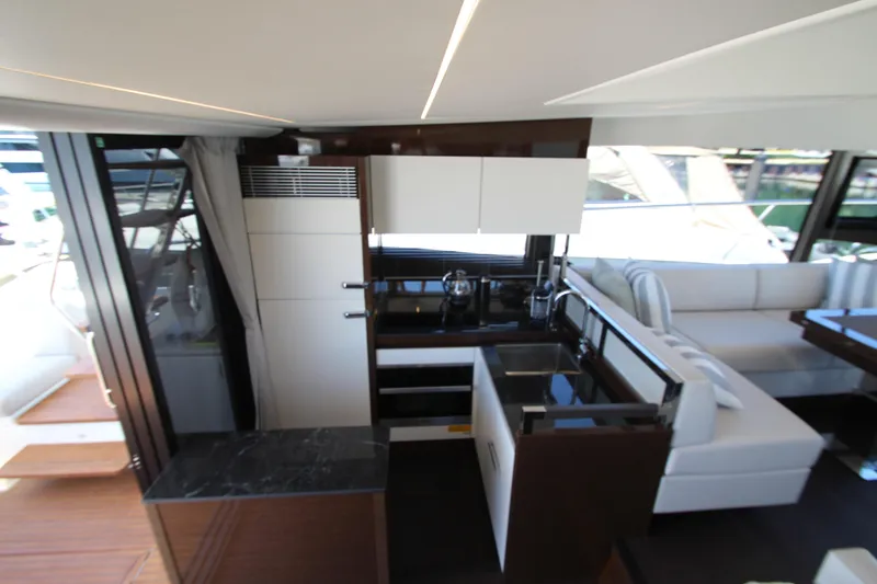 Slide: The Image of Luxurious interior of 2022 Prestige 520 yacht featuring modern kitchen and seating area. - 22