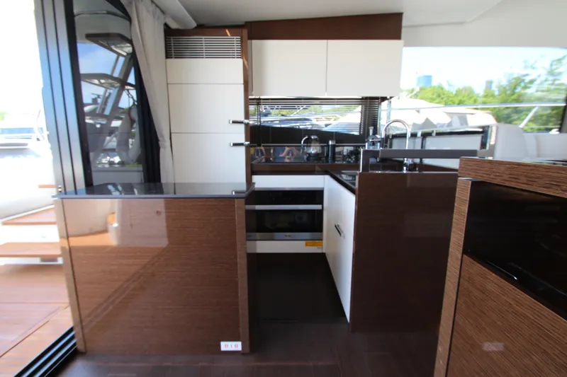 Slide: The Image of Modern kitchen interior on 2022 Prestige 520 yacht, featuring sleek cabinetry and appliances. - 23
