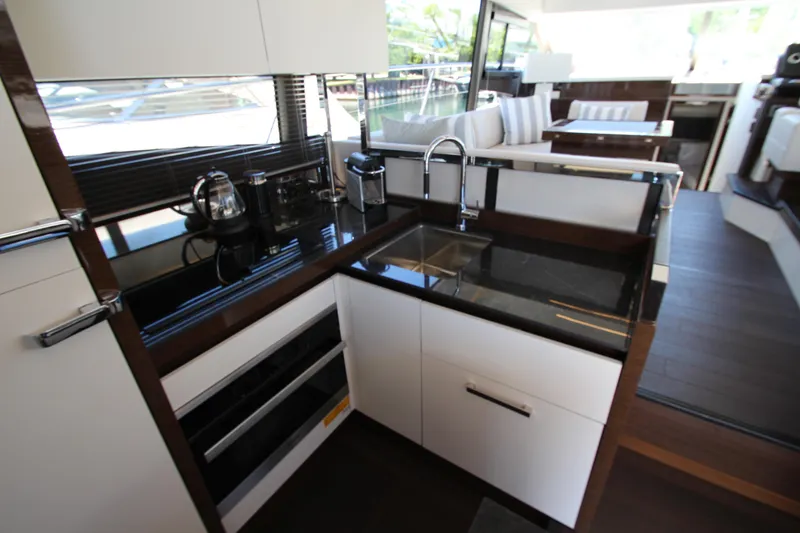Slide: The Image of Modern kitchen interior on 2022 Prestige 520 yacht, featuring sleek countertops and stainless steel appliances. - 25