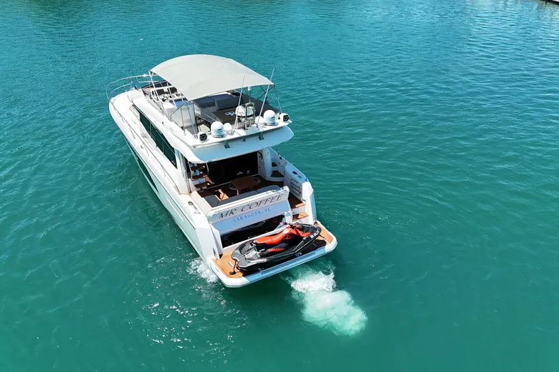 Slide: The Image of Luxury 2022 Prestige 520 yacht cruising on clear blue waters. - 4