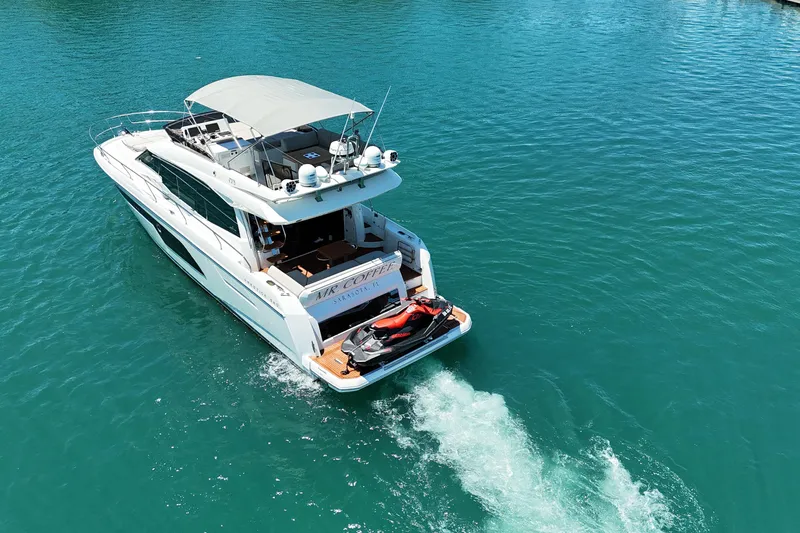 Slide: The Image of Luxury 2022 Prestige 520 yacht cruising on clear blue water. - 5