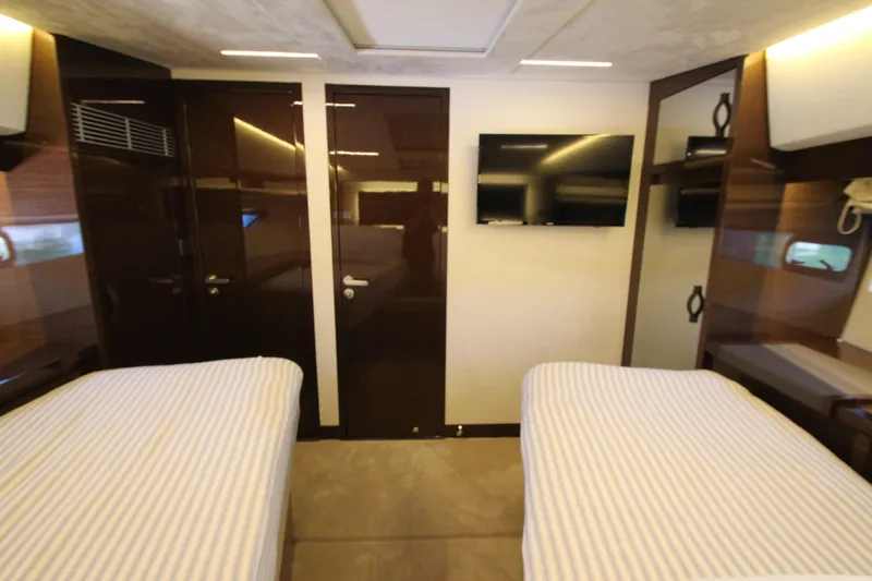 Slide: The Image of Luxurious 2022 Prestige 520 yacht cabin with twin beds and modern amenities. - 55
