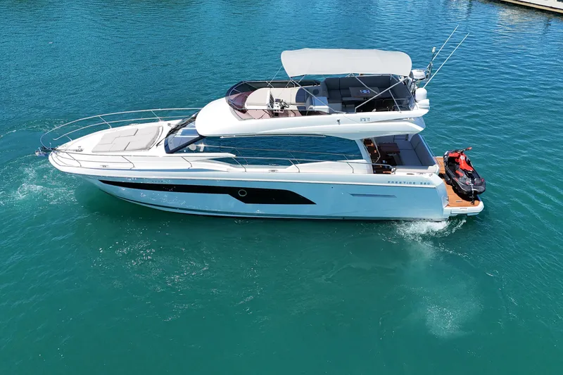 Slide: The Image of 2022 Prestige 520 yacht cruising on clear blue water. - 6
