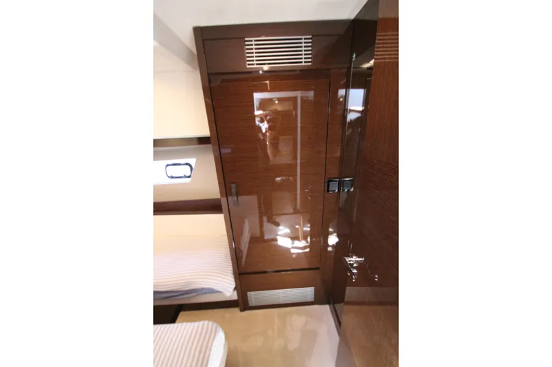 Slide: The Image of Interior of 2022 Prestige 520 yacht with glossy wood finish and modern design. - 60