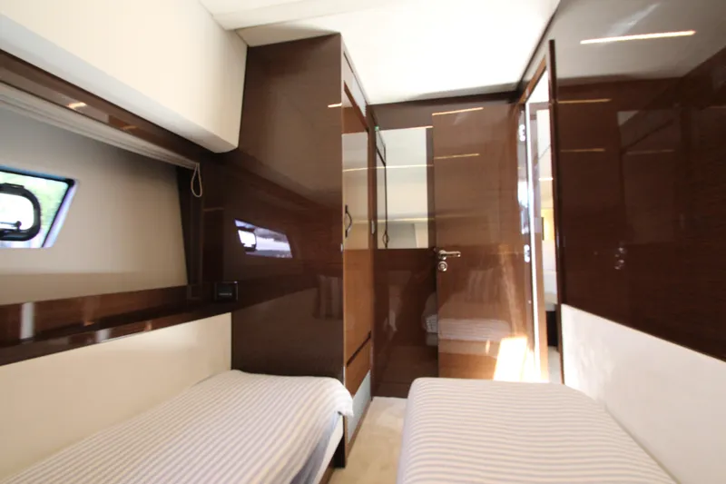 Slide: The Image of Luxurious interior of 2022 Prestige 520 yacht with twin beds and sleek wood finishes. - 62
