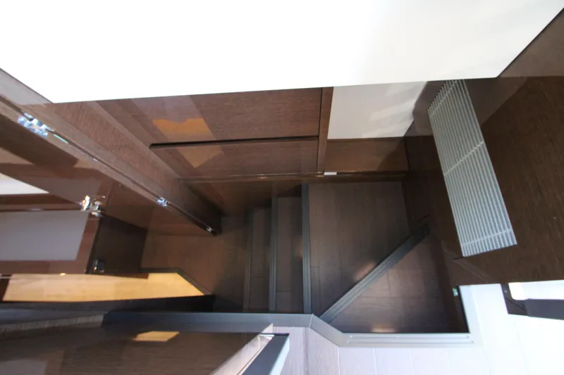 Slide: The Image of Modern interior staircase in 2022 Prestige 520 yacht, featuring sleek wooden design. - 69