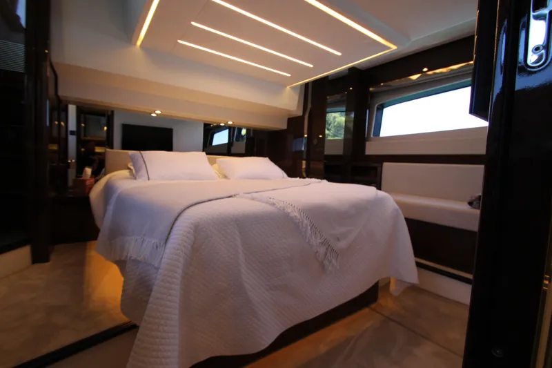 Slide: The Image of Luxurious bedroom interior of 2022 Prestige 520 yacht with modern lighting and elegant bedding. - 75