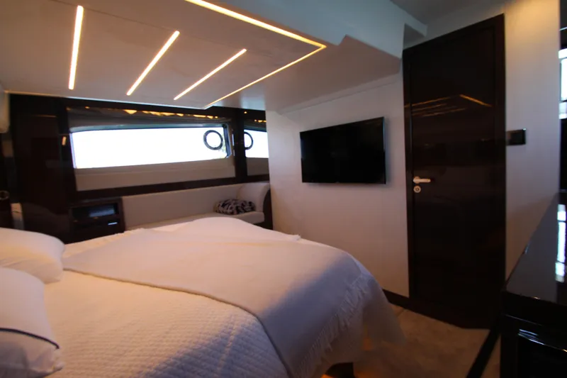 Slide: The Image of Luxurious bedroom interior of 2022 Prestige 520 yacht with modern lighting and sleek design. - 76