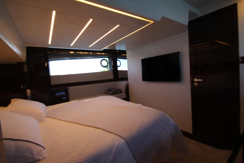 Slide: The Image of Luxurious bedroom interior of 2022 Prestige 520 yacht with modern lighting and TV. - 77