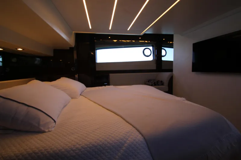 Slide: The Image of Luxurious bedroom interior of 2022 Prestige 520 yacht with modern lighting and elegant bedding. - 78