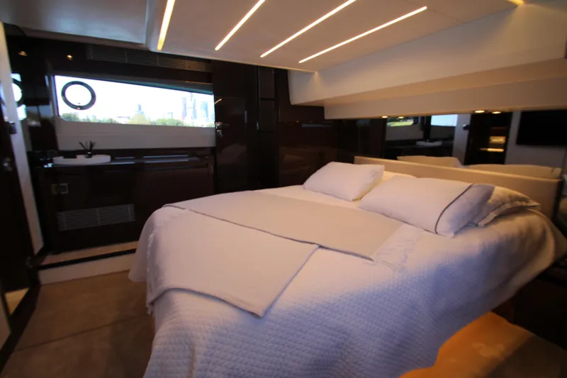 Slide: The Image of Luxurious bedroom interior of 2022 Prestige 520 yacht with modern design and ambient lighting. - 80