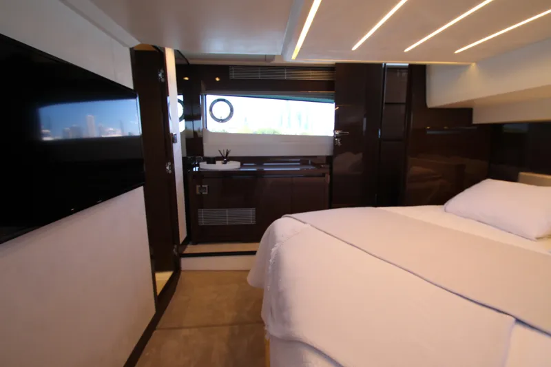 Slide: The Image of Luxurious interior of a 2022 Prestige 520 yacht bedroom with modern design and elegant lighting. - 82