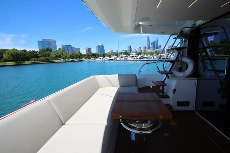 Slide: The Image of Luxurious 2022 Prestige 520 yacht with city skyline and marina view. - 92