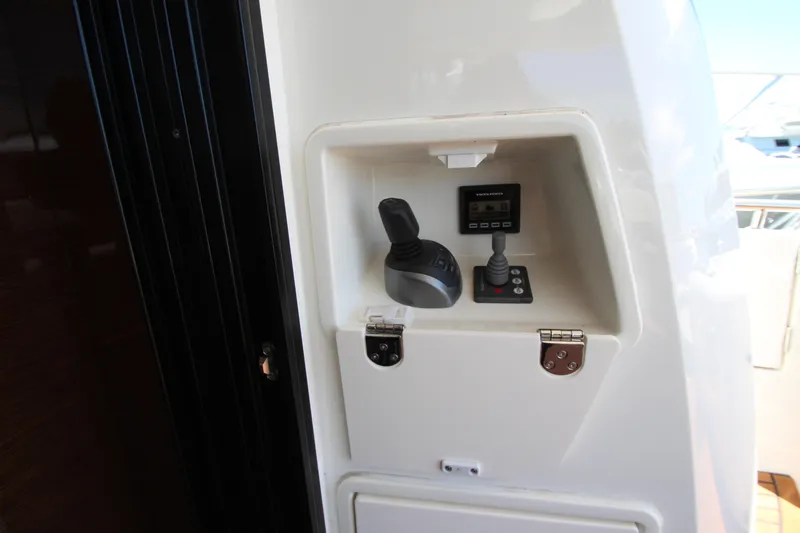 Slide: The Image of Control panel of a 2022 Prestige 520 yacht featuring joystick and display. - 95