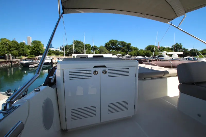 Slide: The Image of Prestige 520 yacht interior, 2022 model, docked in a scenic marina setting. - 98