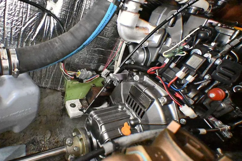 Slide: The Image of Engine compartment of a 1977 Mercator Offshore boat, showcasing wiring and components. - 23