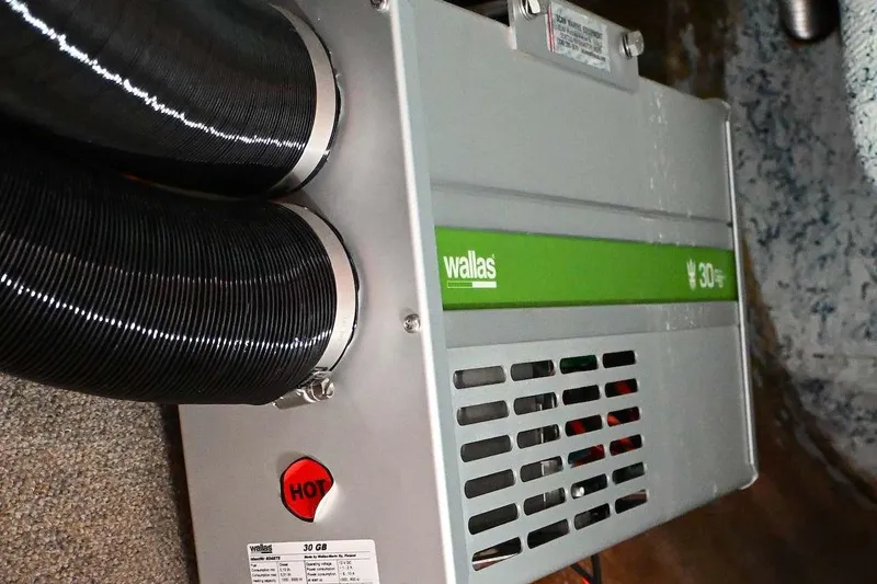 Slide: The Image of Wallas heater unit in a 1977 Mercator Offshore boat, featuring dual exhaust hoses. - 21