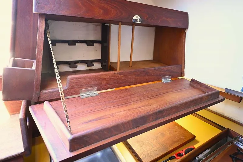 Slide: The Image of Wooden interior cabinet of 1977 Mercator Offshore boat, featuring fold-down desk and storage. - 18