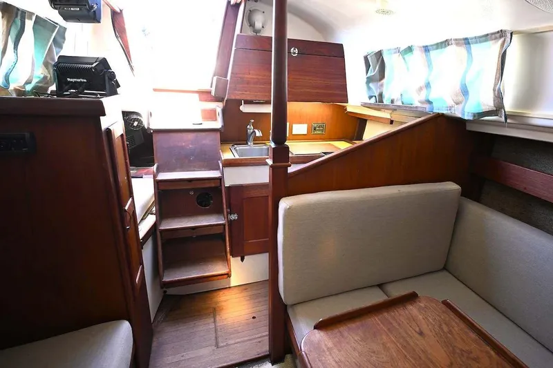 Slide: The Image of Interior of 1977 Mercator Offshore boat with wooden furnishings and compact kitchen area. - 13