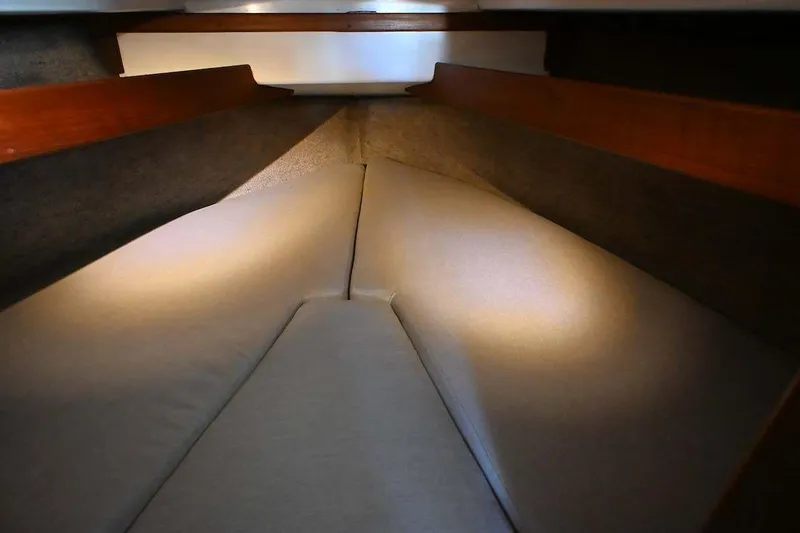 Slide: The Image of Interior cabin view of 1977 Mercator Offshore boat with cushioned sleeping area. - 17