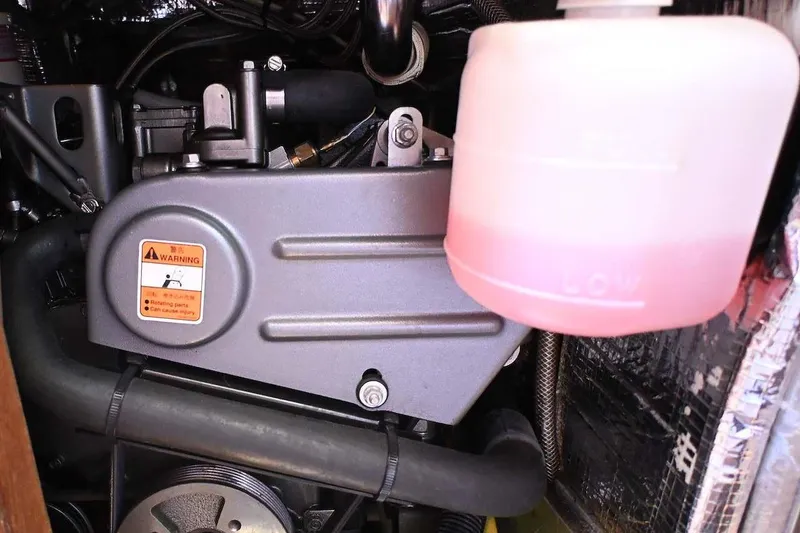 Slide: The Image of Engine compartment of a 1977 Mercator Offshore boat with visible coolant reservoir. - 24