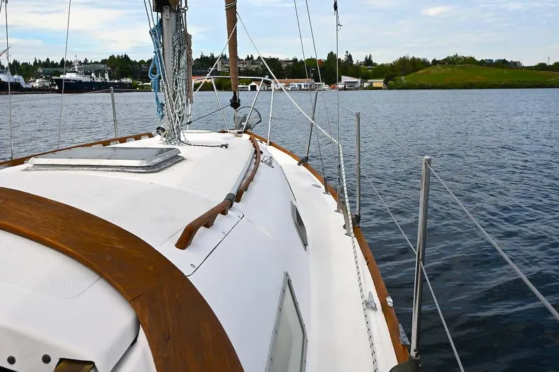 Slide: The Image of 1977 Mercator Offshore sailboat on calm water, showcasing deck and rigging. - 9