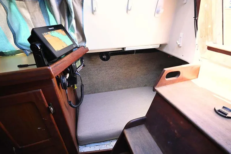 Slide: The Image of Interior of 1977 Mercator Offshore boat with navigation equipment and cozy sleeping area. - 19