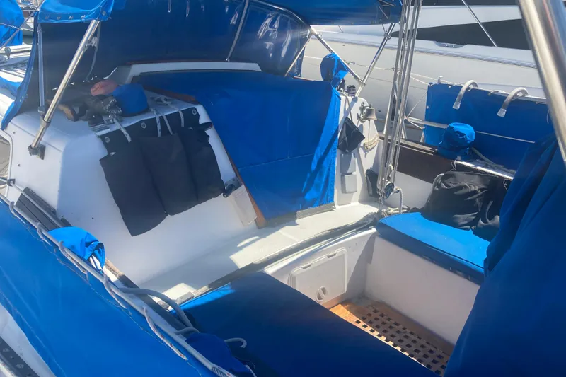 Slide: The Image of 1979 CAL 34-III sailboat cockpit with blue covers and seating. - 12