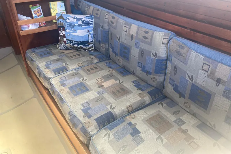 Slide: The Image of Vintage CAL 34-III sailboat interior with patterned cushions and nautical-themed pillow, 1979 model. - 17