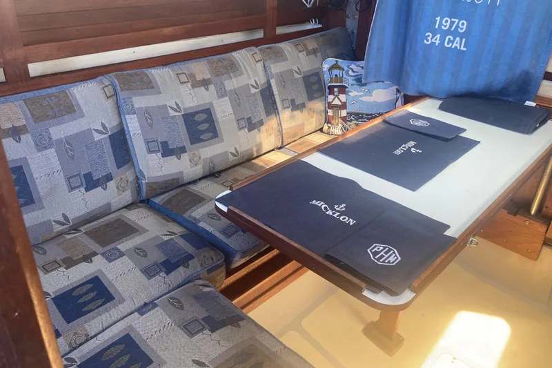 Slide: The Image of Cozy interior of a 1979 CAL 34-III sailboat with patterned seating and nautical decor. - 19