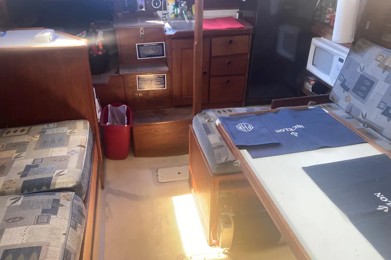 Slide: The Image of Interior of a 1979 CAL 34-III sailboat with seating, table, and kitchenette. - 20