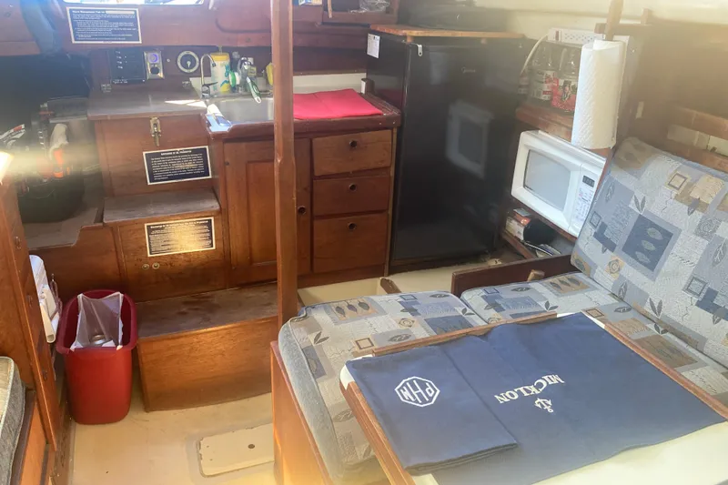 Slide: The Image of Interior of a 1979 CAL 34-III sailboat with kitchenette and seating area. - 21