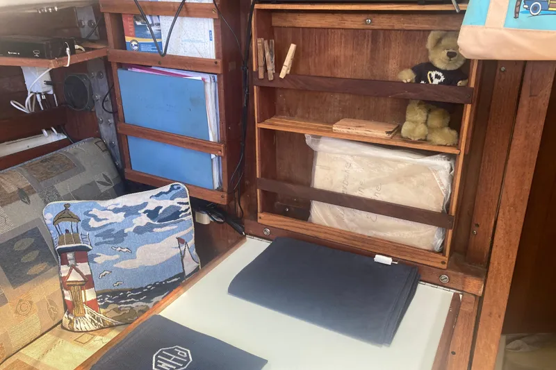 Slide: The Image of Interior of a 1979 CAL 34-III sailboat with nautical decor and storage shelves. - 22